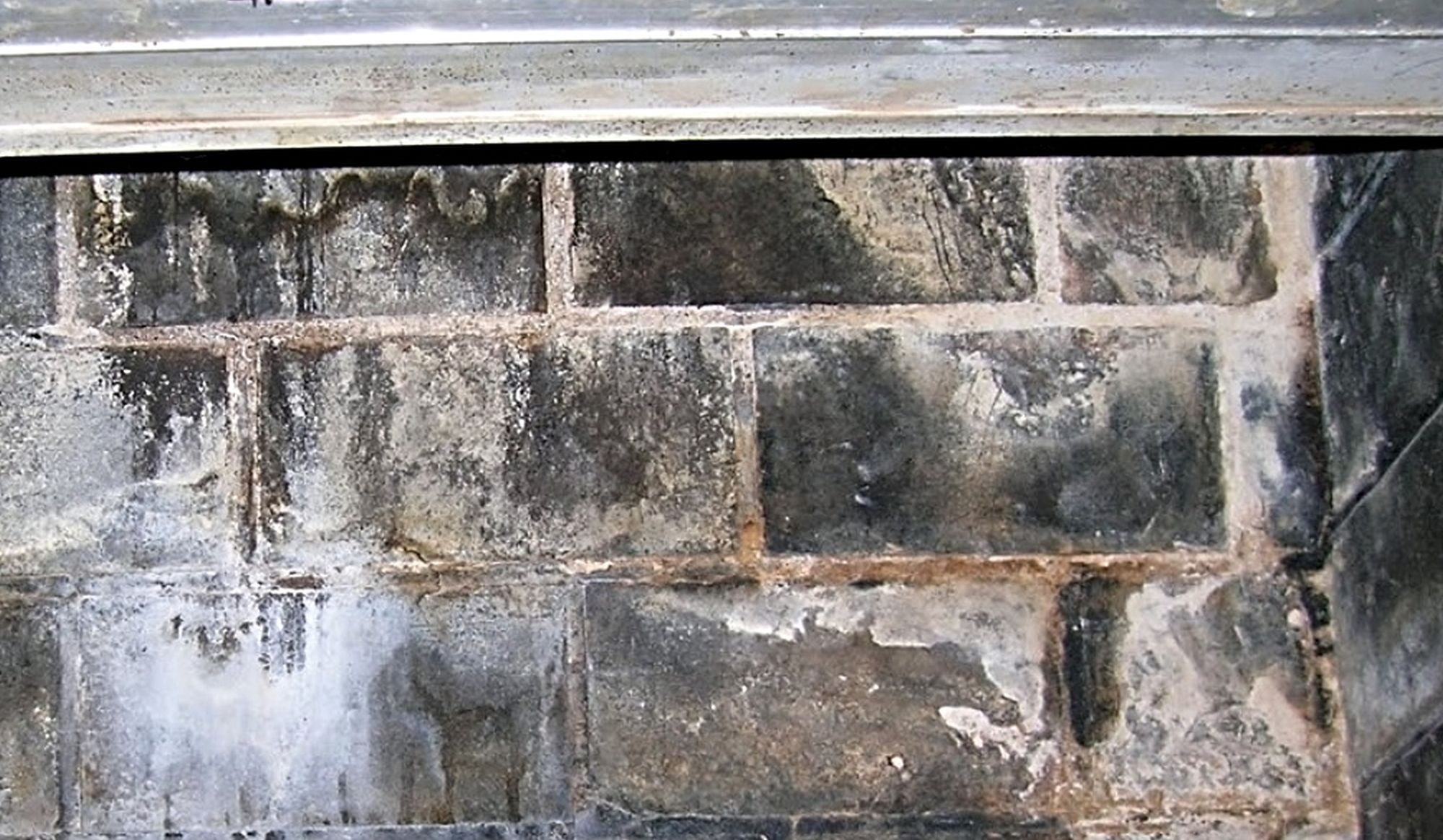 Fireplace is stained by water entering down flue.