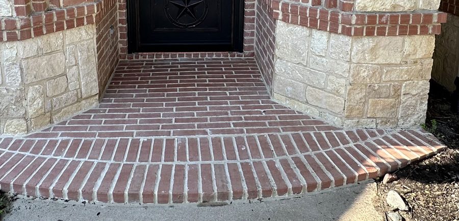 Deteriorated mortar has been ground out and tuck pointed and mismatched brick replaced.