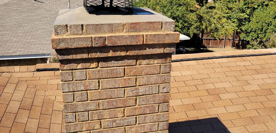 After: A new sloped concrete chimney crown is properly shedding water over the exterior of the chimney bricks.